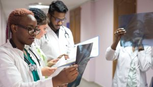 Young doctors, mixed race, in a hospital corridor looking at x-ray images